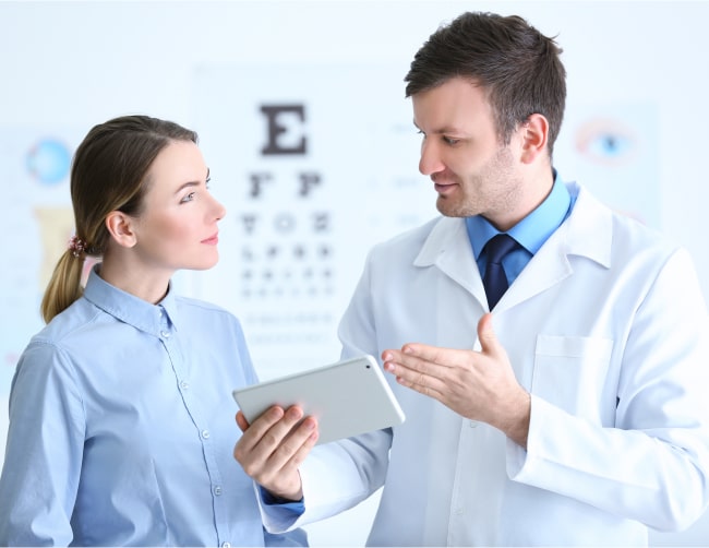 Eye doctor talking to patient, referring them for dry eye treatment at Rejuvenation
