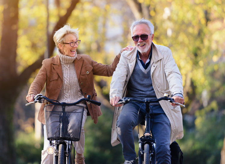 Senior couple happy and smiling while riding bikes