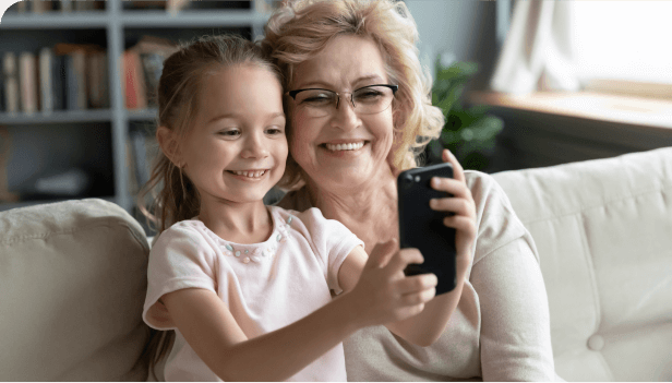 Grandmother and granddaughter using a smartphone