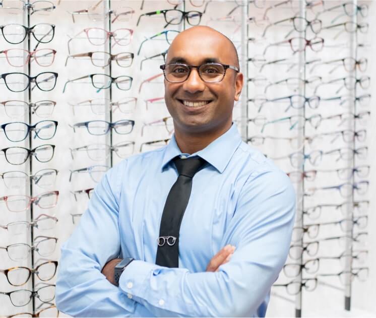 Dr. Nick Lillie standing in front of glasses selection