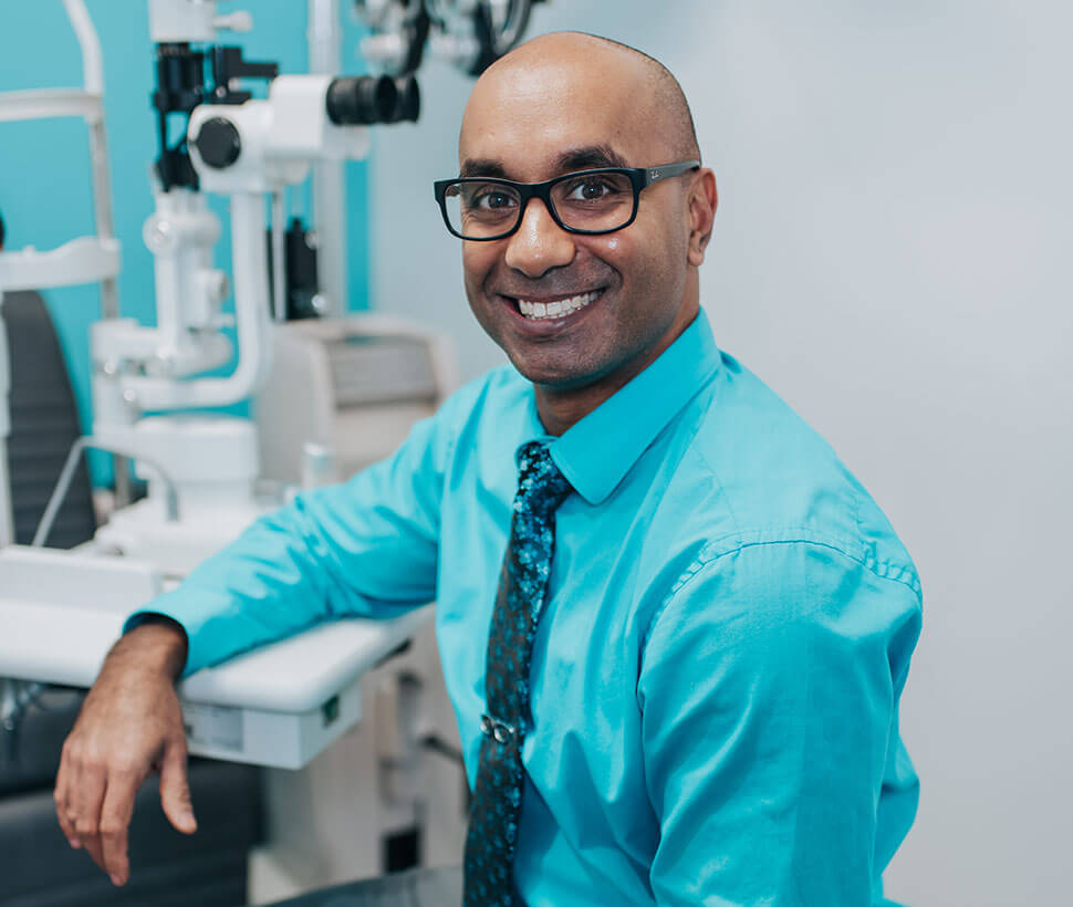 Dr. Nick Lillie standing in front of glasses selection